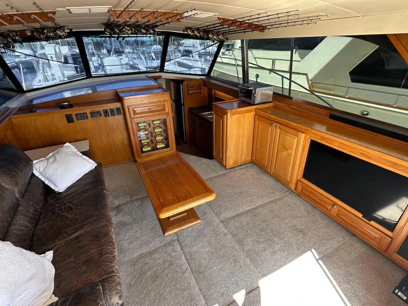 Slide: The Image of 1978 Bertram 46 Convertible yacht interior with wood cabinetry and seating area. - 17