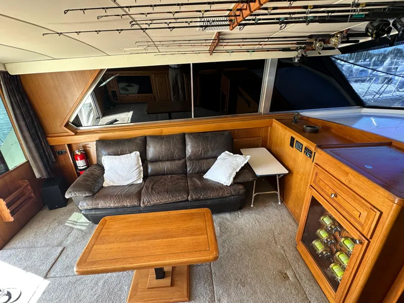 Slide: The Image of Interior of a 1978 Bertram 46 Convertible yacht with leather sofa and wooden table. - 18