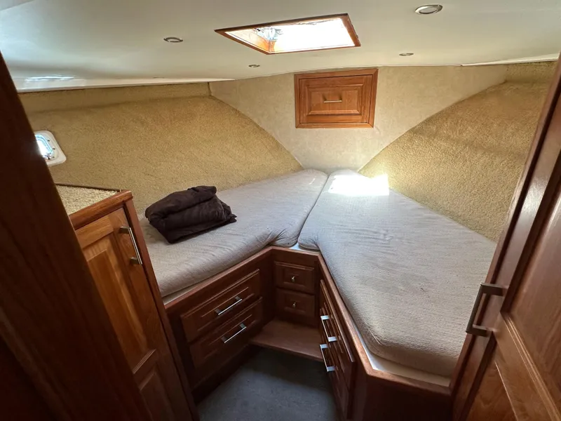 Slide: The Image of 1978 Bertram 46 Convertible cabin interior with cozy twin beds and wooden cabinetry. - 27