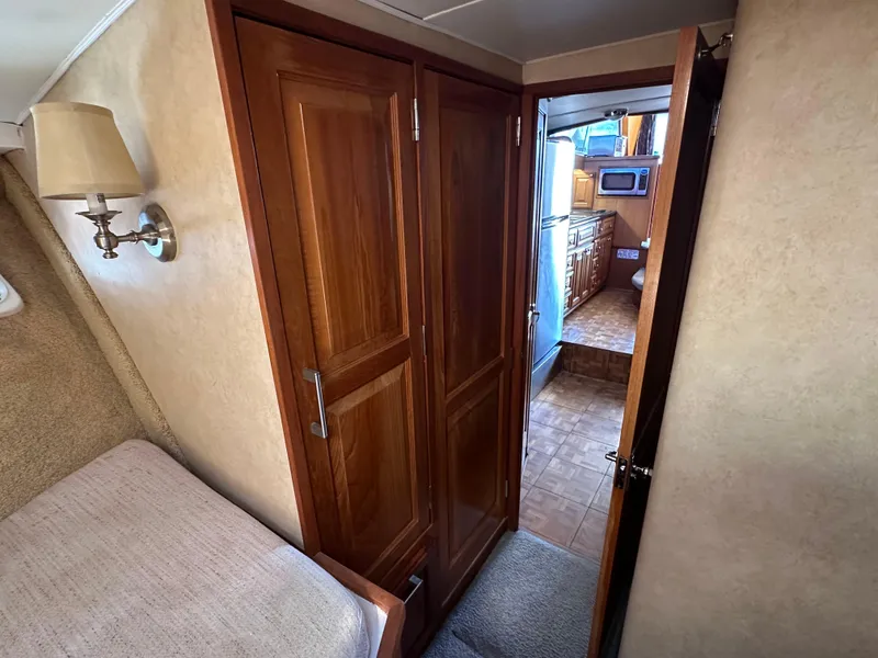Slide: The Image of 1978 Bertram 46 Convertible interior with wooden cabinets and cozy bedroom view. - 29