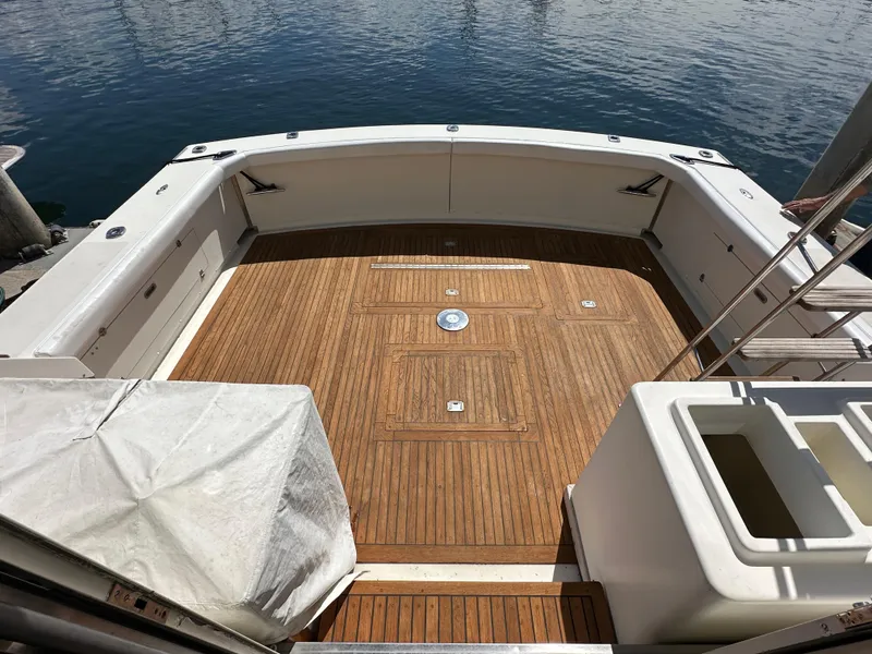 Slide: The Image of 1978 Bertram 46 Convertible yacht with spacious wooden deck at the stern. - 30