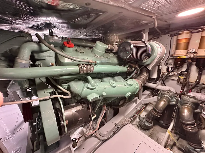 Slide: The Image of Engine room of a 1978 Bertram 46 Convertible boat, showcasing detailed machinery and components. - 32