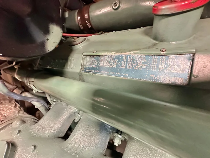 Slide: The Image of Engine detail of a 1978 Bertram 46 Convertible boat, showcasing a metal identification plate. - 34