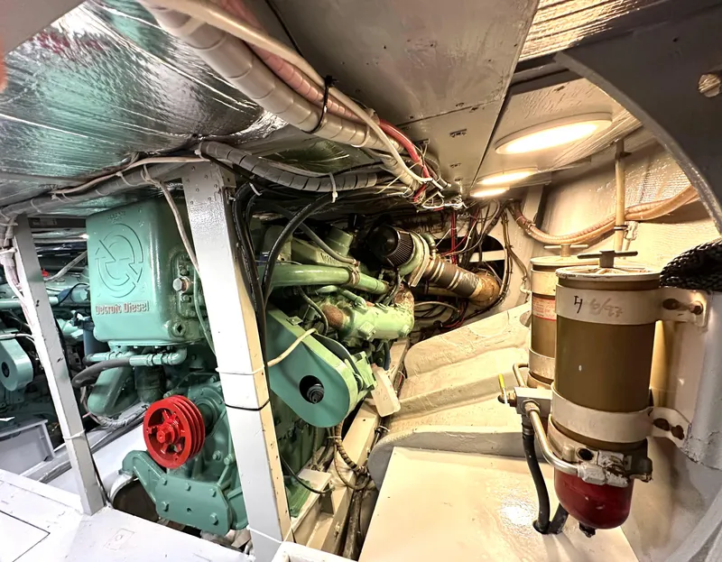 Slide: The Image of Engine room of a 1978 Bertram 46 Convertible boat, showcasing mechanical components and wiring. - 37