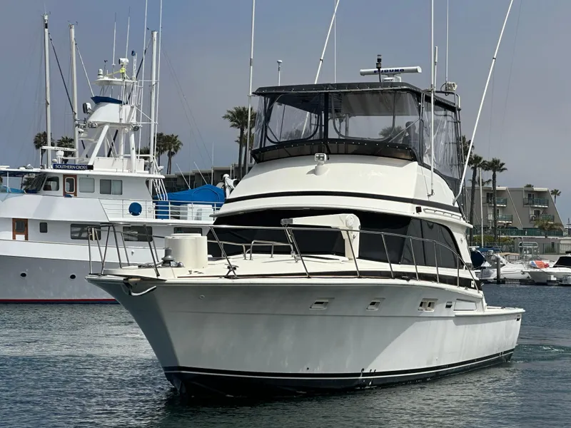 Slide: The Image of 1978 Bertram 46 Convertible yacht docked in marina, featuring classic design and spacious deck. - 5