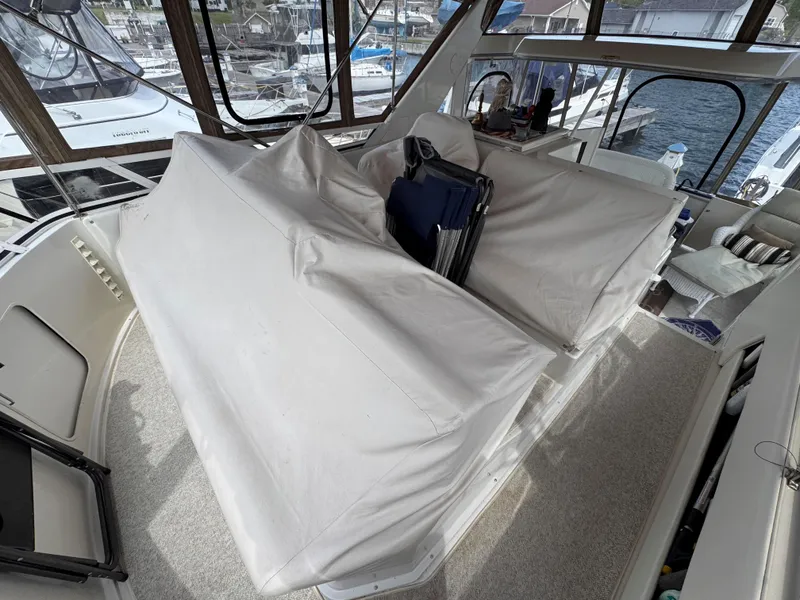 Slide: The Image of 1999 Carver 406 Aft Cabin Motor Yacht interior with covered seating area. - 13