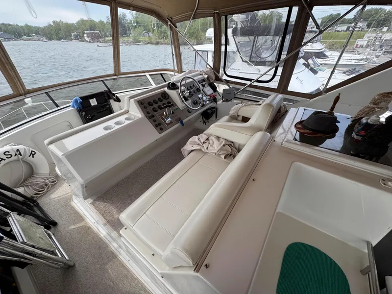 Slide: The Image of 1999 Carver 406 Aft Cabin Motor Yacht interior with helm and seating area. - 14
