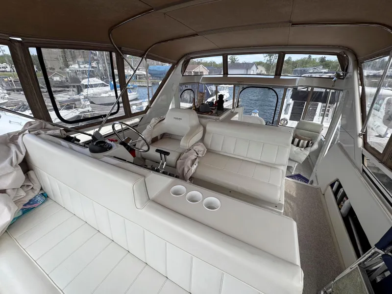 Slide: The Image of 1999 Carver 406 Aft Cabin Motor Yacht interior with white seating and helm station. - 15