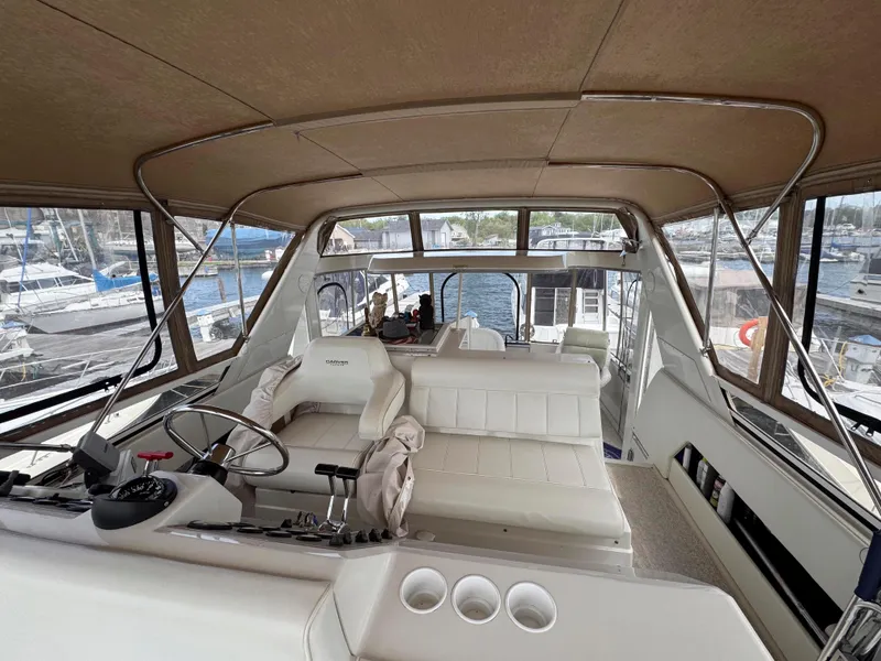 Slide: The Image of 1999 Carver 406 Aft Cabin Motor Yacht interior with helm and seating area. - 16