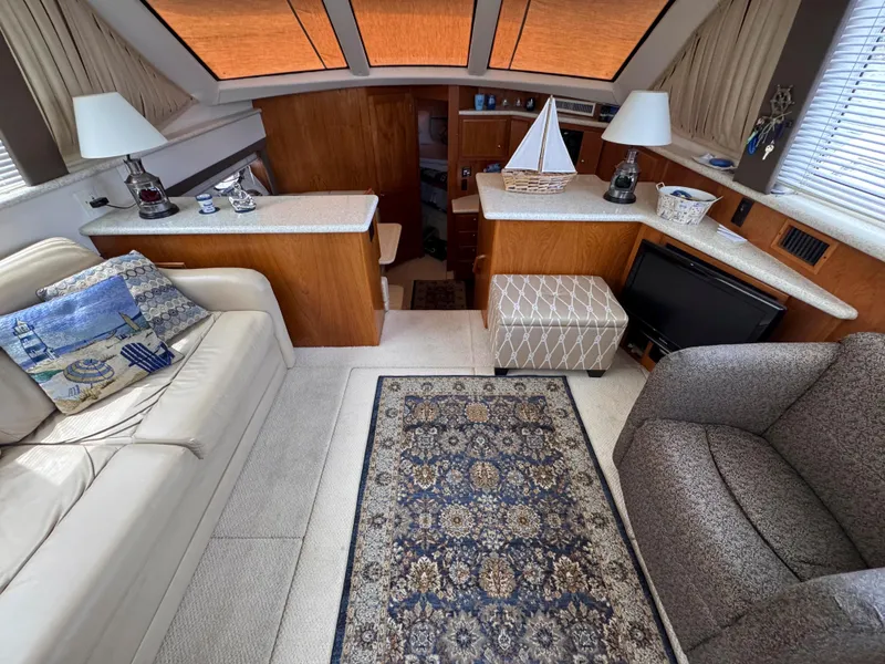 Slide: The Image of Interior of 1999 Carver 406 Aft Cabin Motor Yacht with cozy seating and nautical decor. - 20
