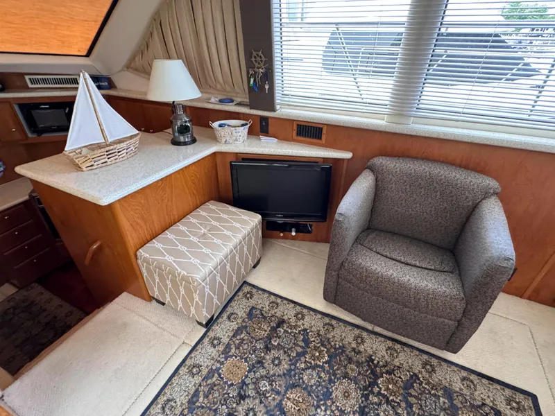 Slide: The Image of Interior of 1999 Carver 406 Aft Cabin Motor Yacht with cozy seating and decor. - 21
