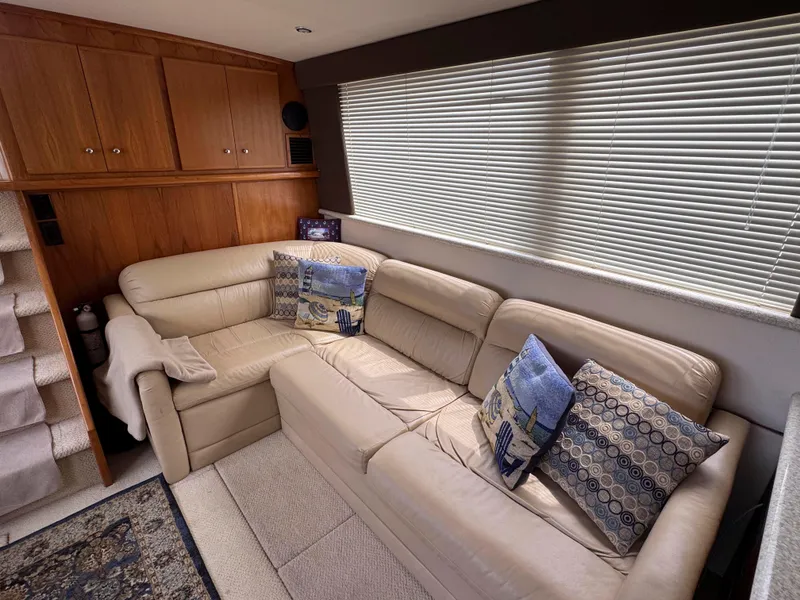 Slide: The Image of Luxurious interior of 1999 Carver 406 Aft Cabin Motor Yacht with plush seating and decorative pillows. - 22