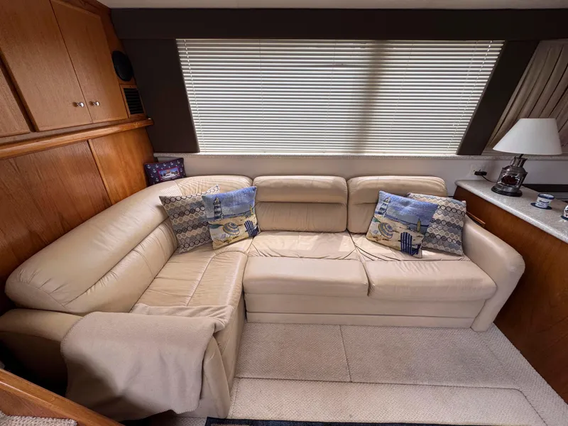 Slide: The Image of Luxurious interior of 1999 Carver 406 Aft Cabin Motor Yacht with beige leather seating. - 23