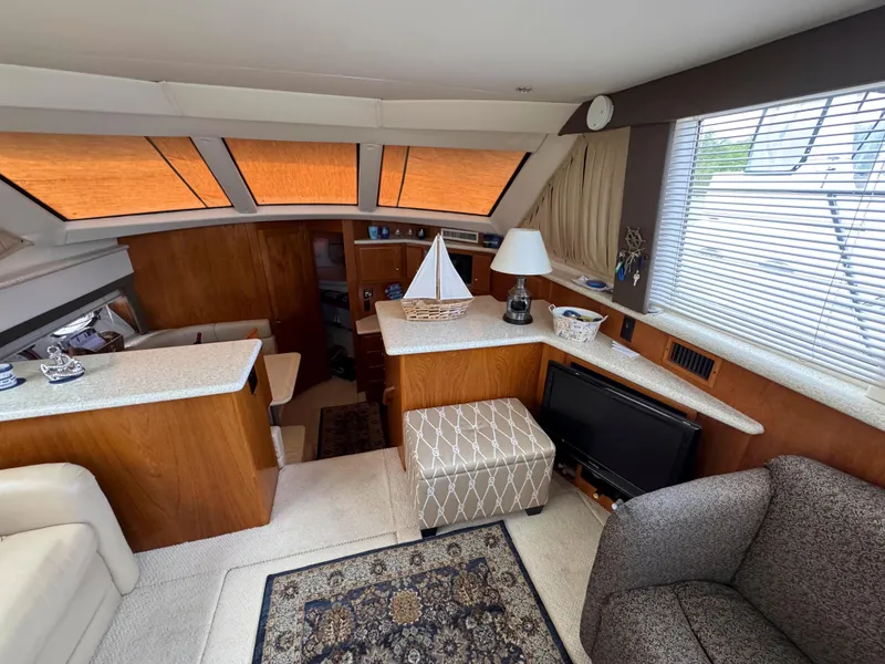 Slide: The Image of Interior of 1999 Carver 406 Aft Cabin Motor Yacht with cozy seating and decor. - 25