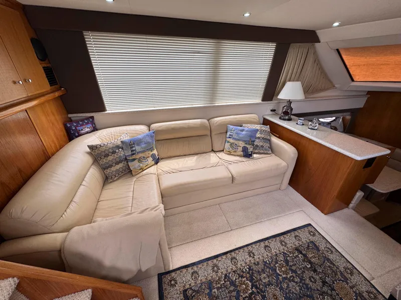 Slide: The Image of Luxurious interior of 1999 Carver 406 Aft Cabin Motor Yacht with plush seating and elegant decor. - 26