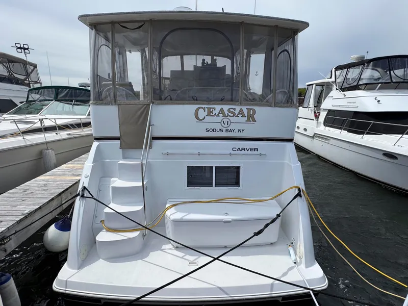 Slide: The Image of 1999 Carver 406 Aft Cabin Motor Yacht docked at marina, rear view. - 3