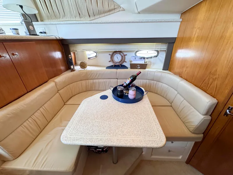 Slide: The Image of 1999 Carver 406 Aft Cabin Motor Yacht interior with cozy dining area and elegant decor. - 30