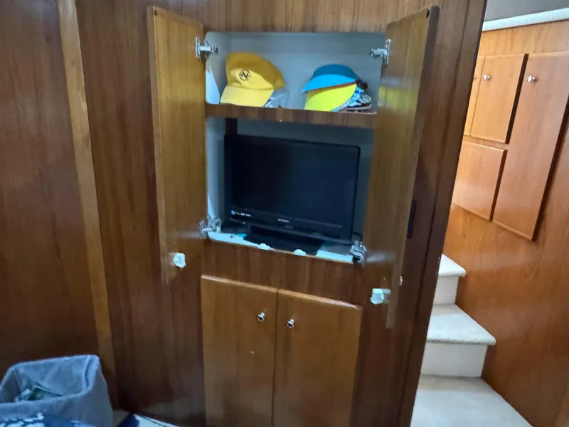 Slide: The Image of 1999 Carver 406 Aft Cabin Motor Yacht interior with TV and storage cabinet. - 34