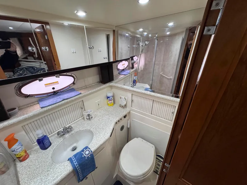 Slide: The Image of 1999 Carver 406 Aft Cabin Motor Yacht bathroom with sink, toilet, and shower. - 36