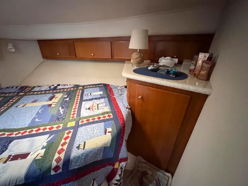 Slide: The Image of Cozy cabin interior of 1999 Carver 406 Aft Cabin Motor Yacht with nautical-themed bedding. - 37