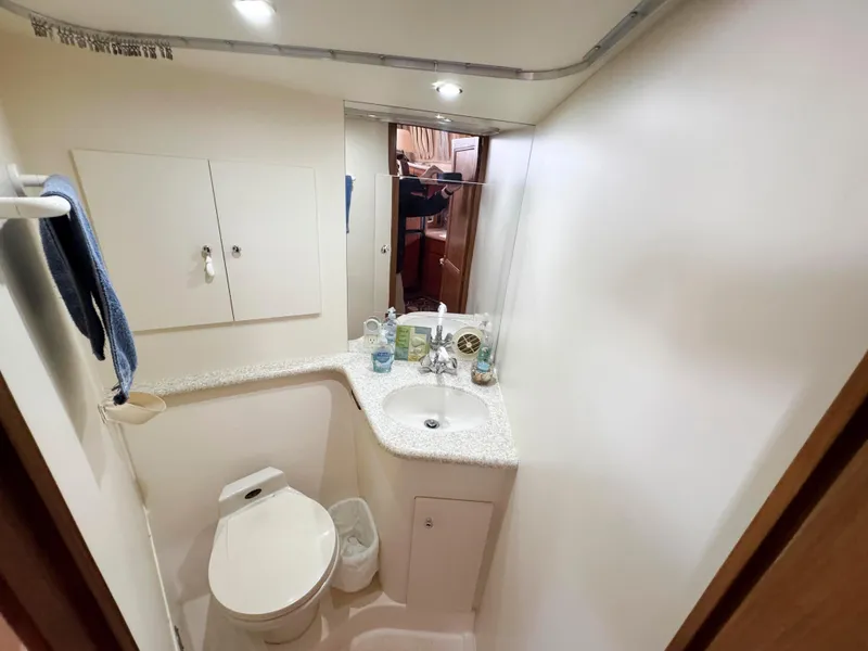 Slide: The Image of Bathroom interior of 1999 Carver 406 Aft Cabin Motor Yacht, featuring sink and toilet. - 38