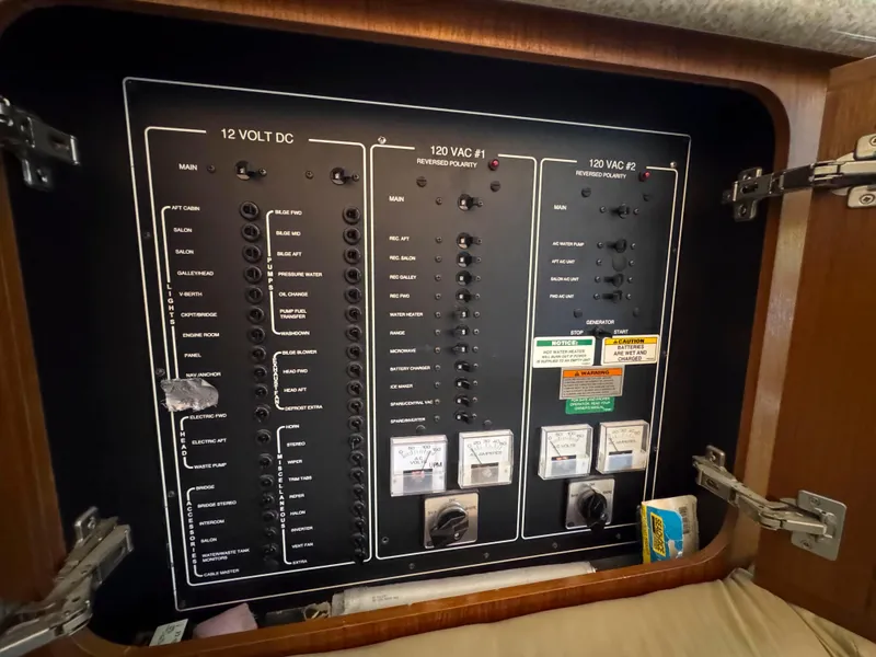 Slide: The Image of Electrical panel inside 1999 Carver 406 Aft Cabin Motor Yacht, featuring 12V and 120V systems. - 40