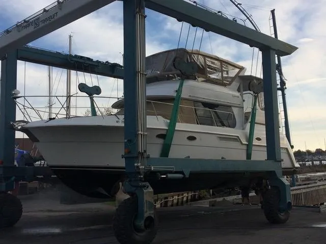Slide: The Image of 1999 Carver 406 Aft Cabin Motor Yacht in dry dock, supported by a boat lift. - 6