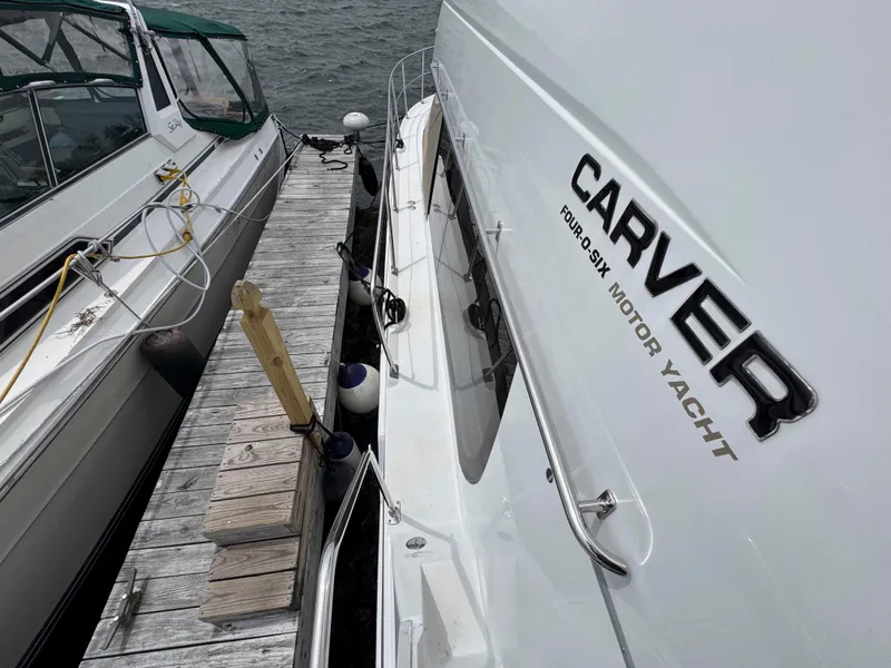 Slide: The Image of 1999 Carver 406 Aft Cabin Motor Yacht docked beside another boat. - 8