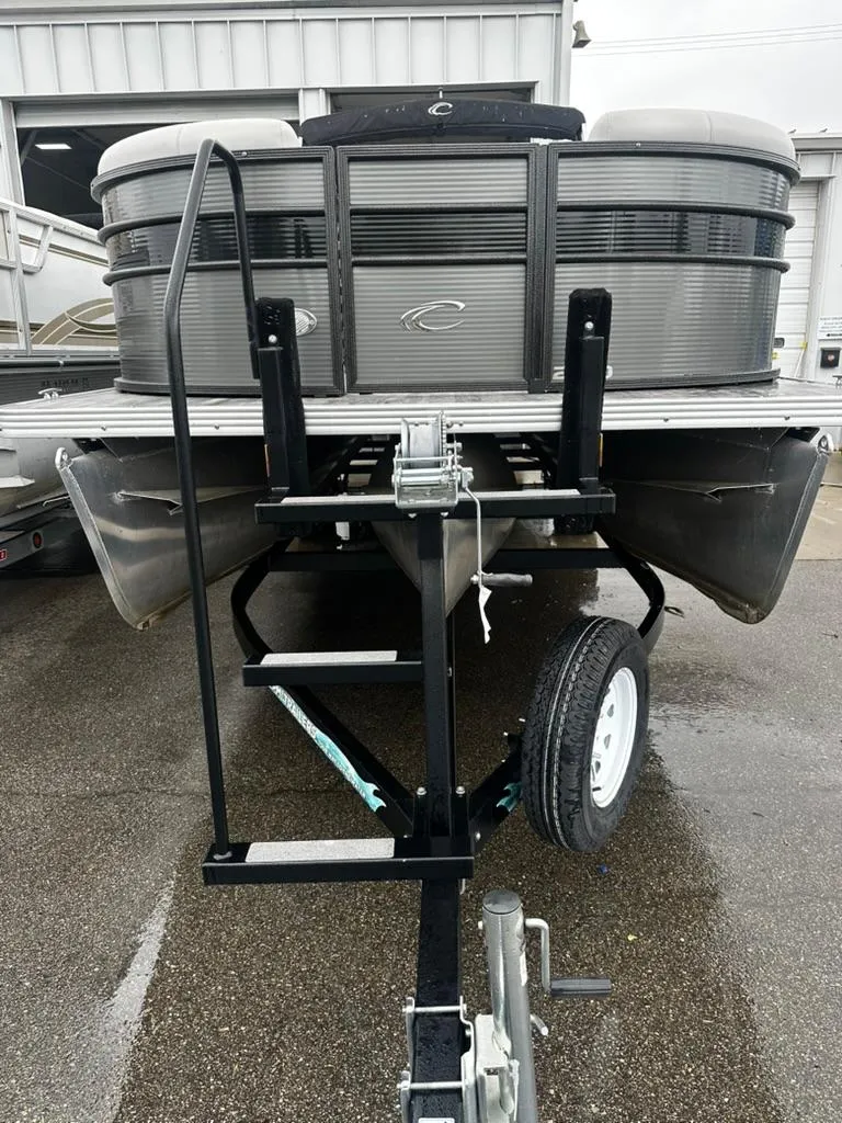Slide: The Image of 2021 Crest Classic LX 240 SLS pontoon boat on trailer, front view. - 1