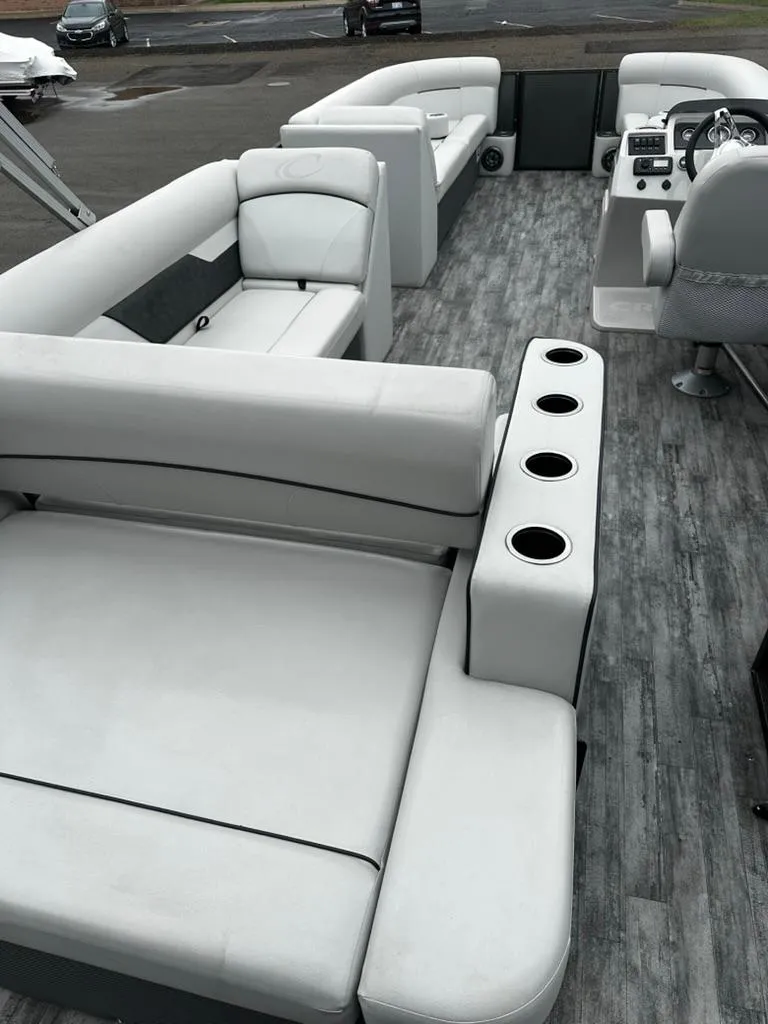 Slide: The Image of 2021 Crest Classic LX 240 SLS pontoon boat with spacious seating and modern interior design. - 10