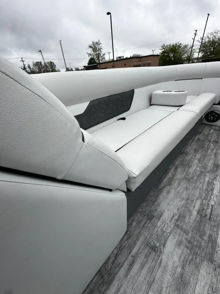 Slide: The Image of 2021 Crest Classic LX 240 SLS boat interior with sleek seating and modern design. - 6