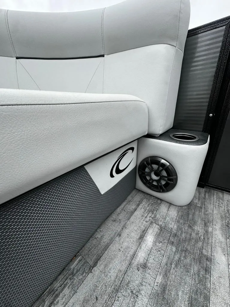 Slide: The Image of 2021 Crest Classic LX 240 SLS boat interior with speaker and cushioned seating. - 7