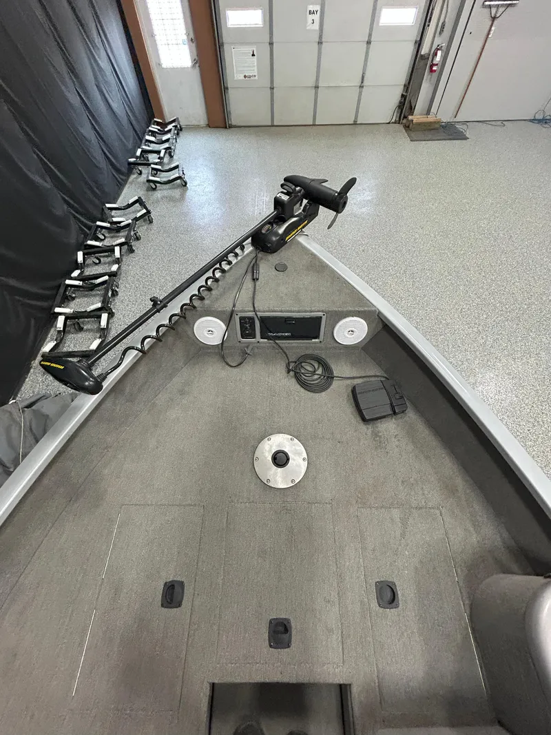 Slide: The Image of 2005 Tracker Targa 17 SC boat interior with trolling motor in a garage. - 10