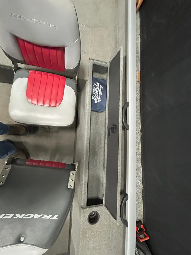 Slide: The Image of 2005 Tracker Targa 17 SC boat interior with red and gray seats and storage compartment. - 12
