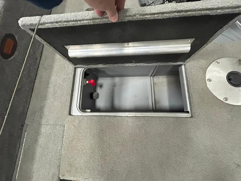 Slide: The Image of 2005 Tracker Targa 17 SC boat storage compartment with open lid, showing interior space. - 14