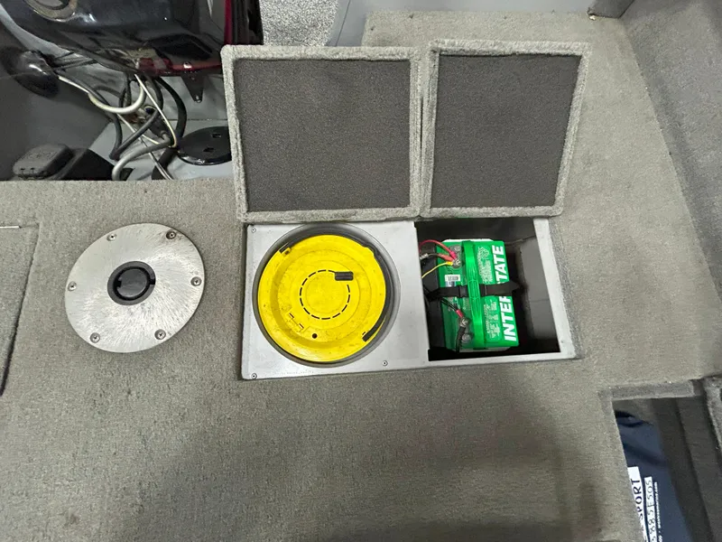 Slide: The Image of 2005 Tracker Targa 17 SC boat interior with battery compartment and storage. - 15