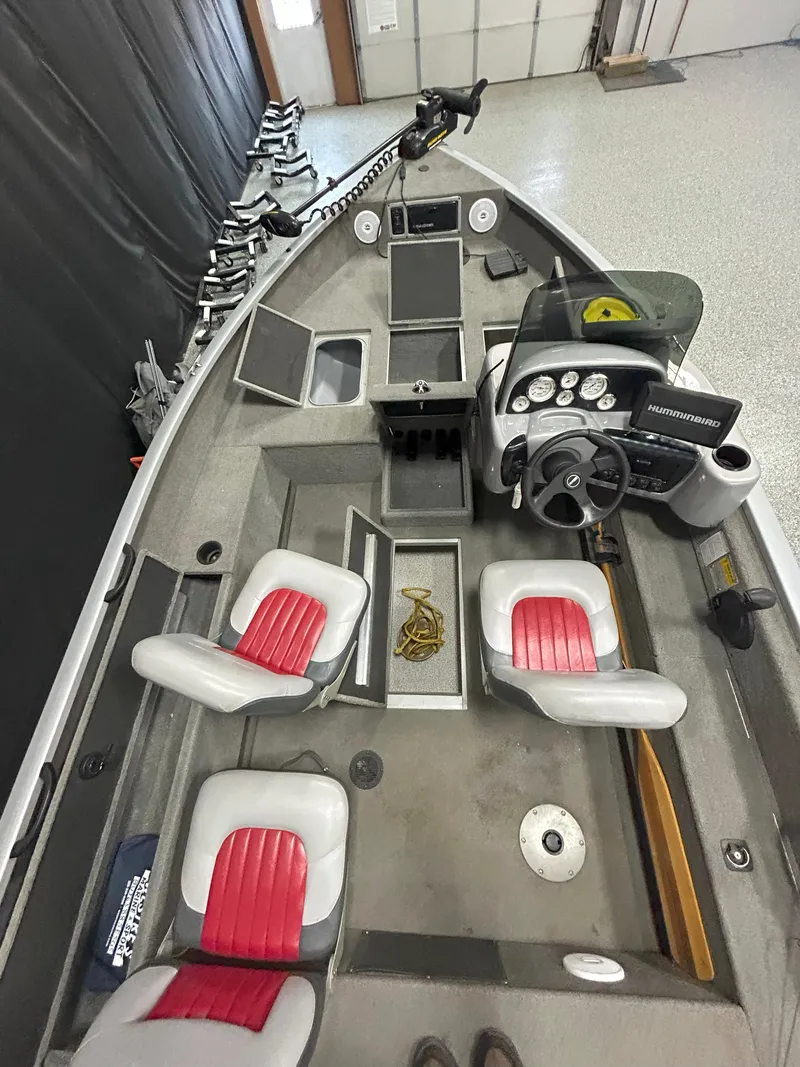 Slide: The Image of 2005 Tracker Targa 17 SC boat interior with red and white seats, steering console, and storage compartments. - 16
