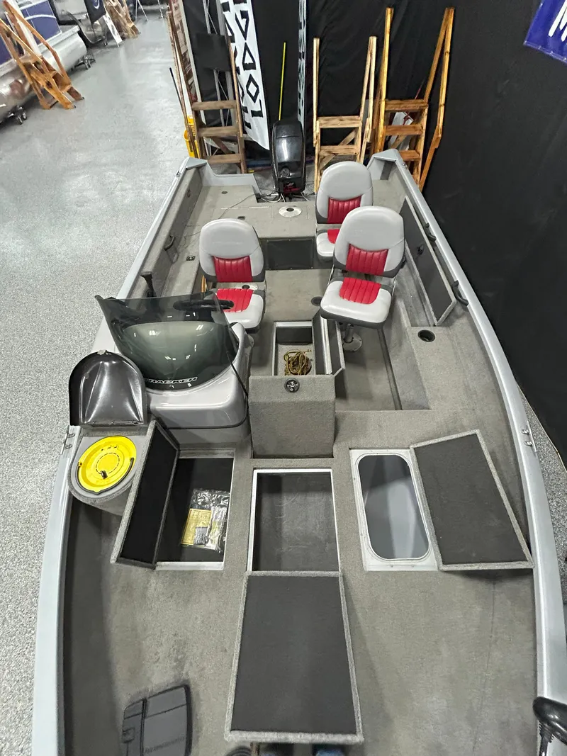 Slide: The Image of 2005 Tracker Targa 17 SC fishing boat interior with seating and storage compartments. - 17