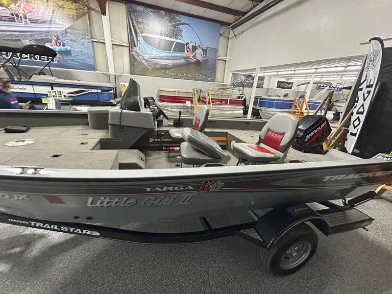 Slide: The Image of 2005 Tracker Targa 17 SC boat displayed indoors with seating and motor. - 6