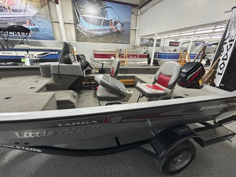 Slide: The Image of 2005 Tracker Targa 17 SC boat with dual seats in a showroom. - 7