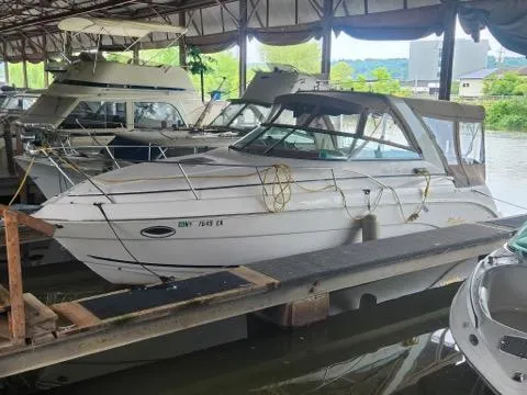 Slide: The Image of 2004 Rinker Fiesta Vee 290 docked in a covered marina. - 3