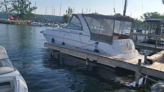 Slide: The Image of 2004 Rinker Fiesta Vee 290 boat docked at a marina with canopy cover. - 4