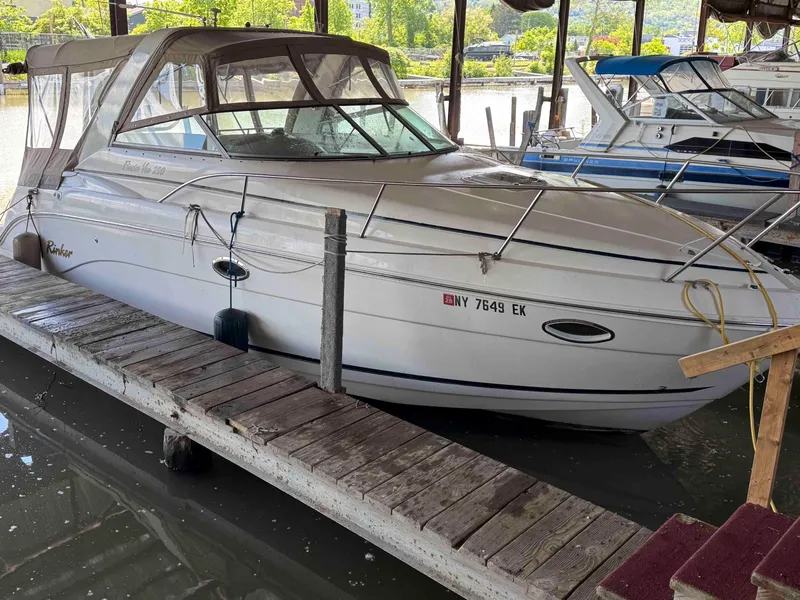 Slide: The Image of 2004 Rinker Fiesta Vee 290 docked in a marina, covered with a canopy. - 5