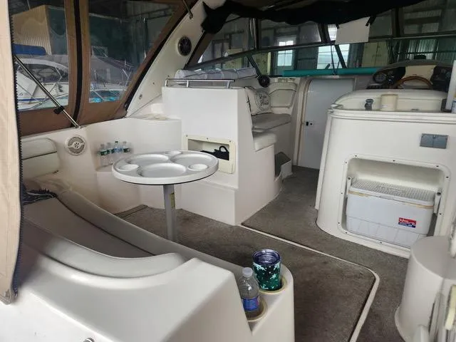 Slide: The Image of 2004 Rinker Fiesta Vee 290 boat interior with seating, table, and helm station. - 6