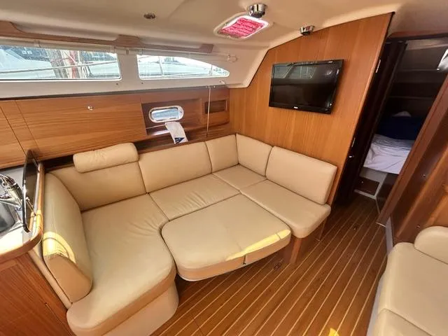 Slide: The Image of Interior of 2015 Catalina 315 yacht with beige seating and wood paneling. - 10
