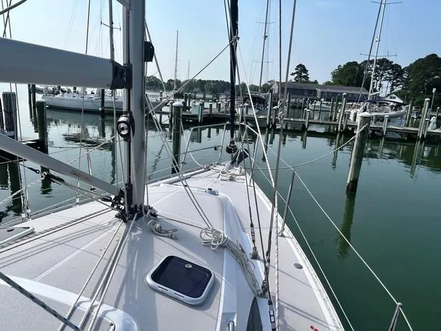 Slide: The Image of Sailboat Catalina 315, 2015 model, docked at a marina with calm waters. - 3