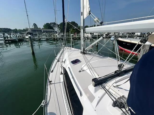 Slide: The Image of 2015 Catalina 315 sailboat docked at a marina, clear sky, calm water. - 4