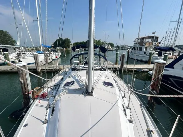 Slide: The Image of 2015 Catalina 315 sailboat docked at a marina, surrounded by other boats. - 7