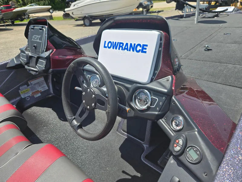 Slide: The Image of 2018 Skeeter ZX 250 boat dashboard with Lowrance electronics and steering wheel. - 10