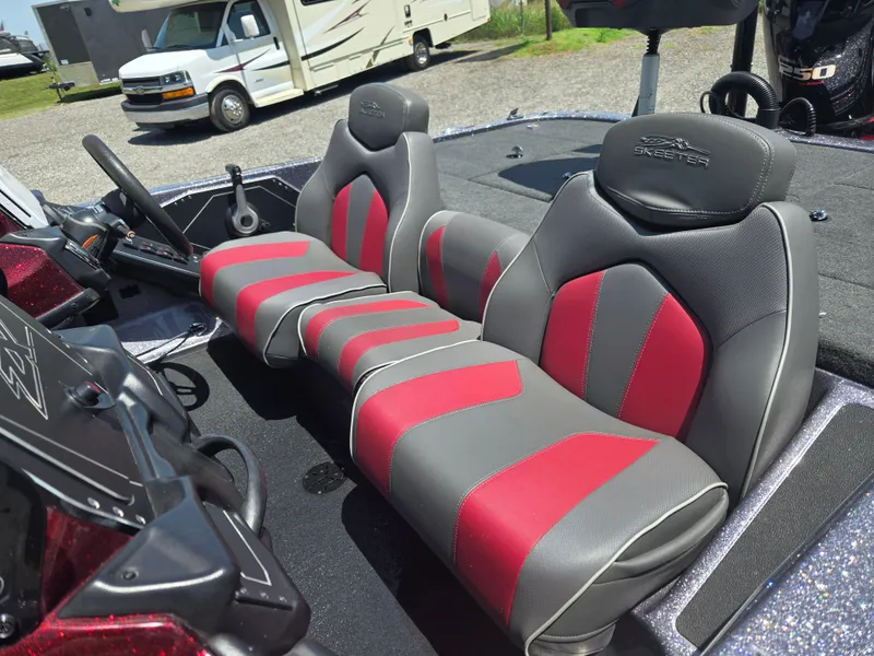 Slide: The Image of 2018 Skeeter ZX 250 boat interior with red and gray seats, steering wheel, and dashboard. - 11